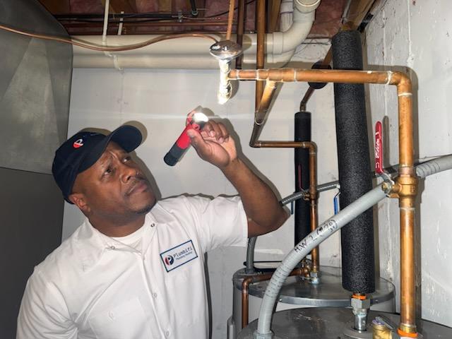 plumbifi team member inspecting pipes for leakage