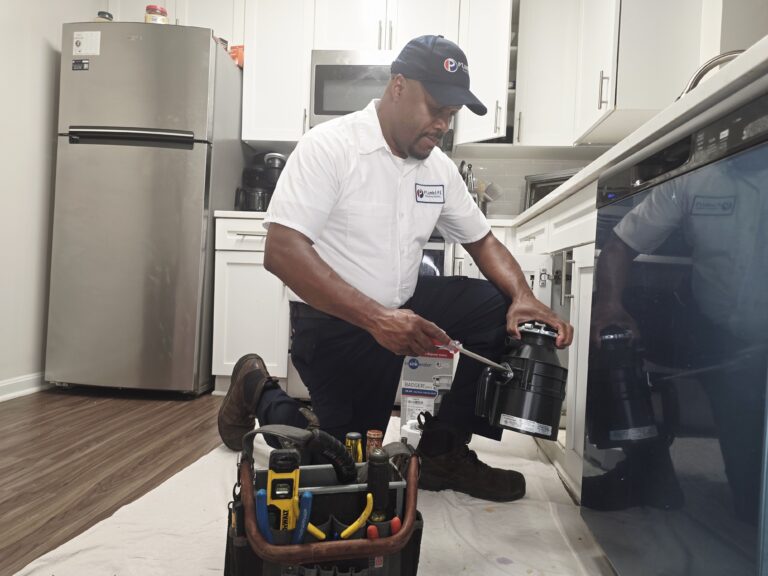plumbifi plumbers working in a kitchen at a client home